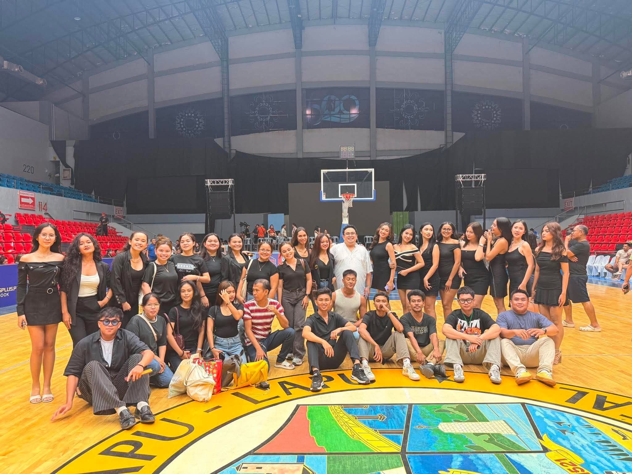 Production team and talents gathered on an arena court